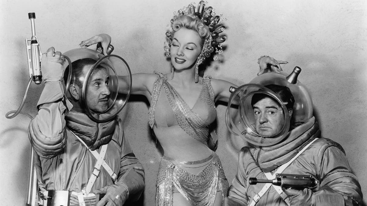 Mari Blanchard in a glamorous costume in the center of Abbott and Costello in scuba gear
