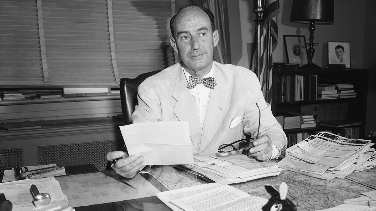 Adlai Stevenson holding telegrams