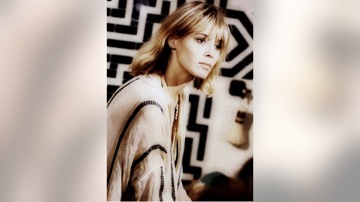 Anita Pallenberg wearing a white and black dress