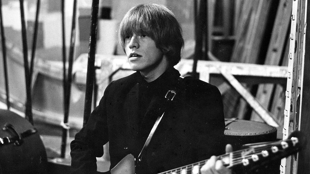 A close-up of Brian Jones playing the guitar