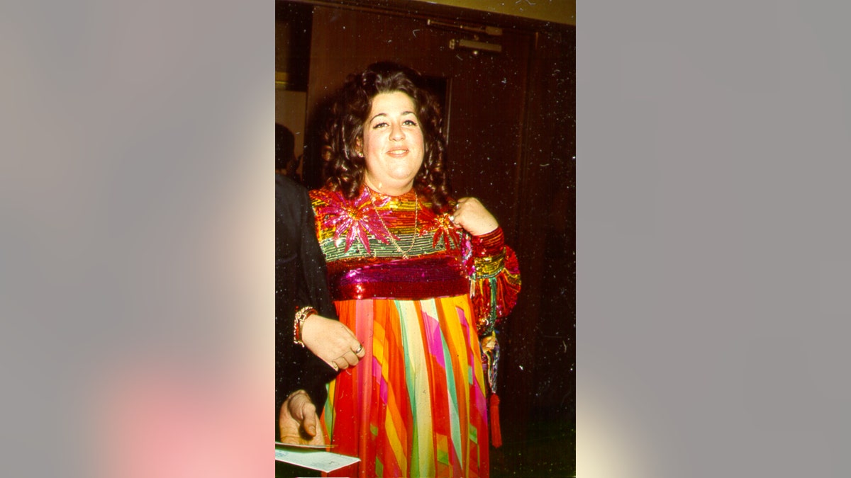 Cass Elliot wearing a colorful dress