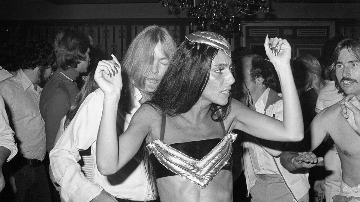 Cher and Gregg Allman dancing in a club