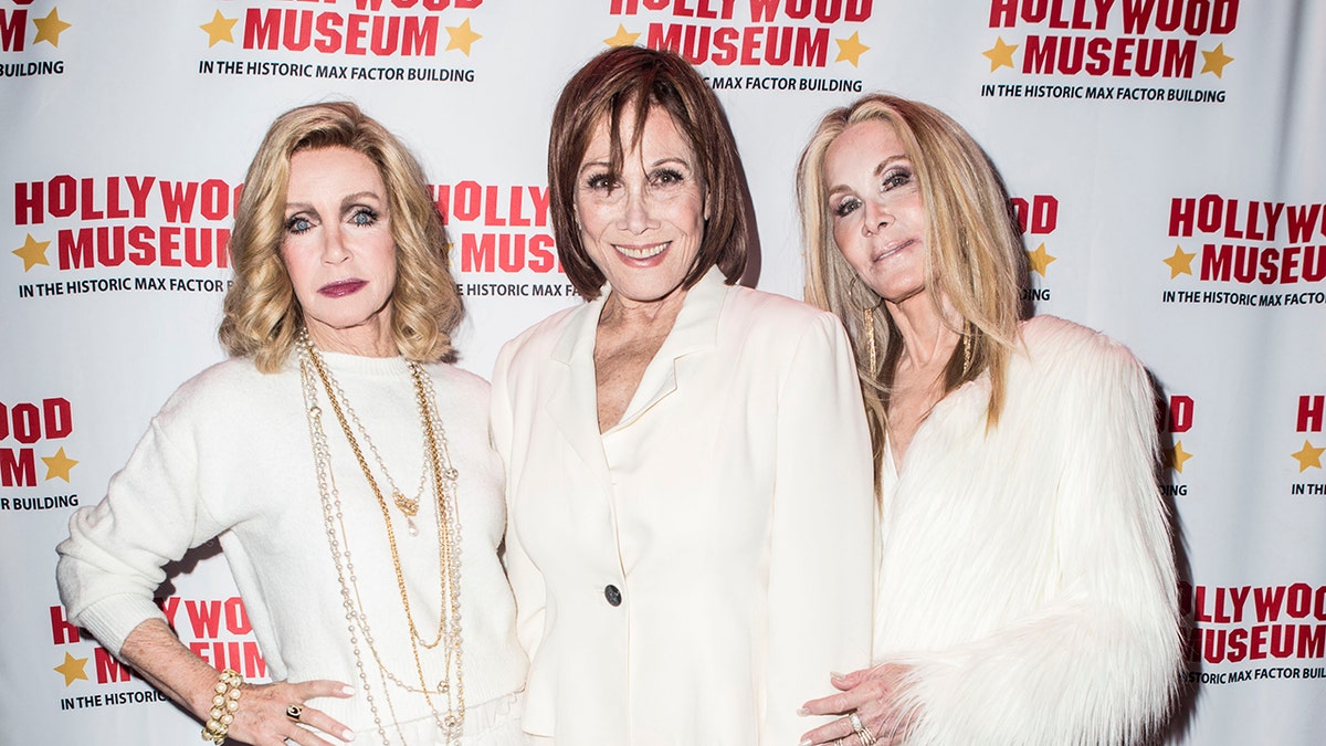 Donna Mills, Michele Lee and Joan Van Ark all wearing white suits