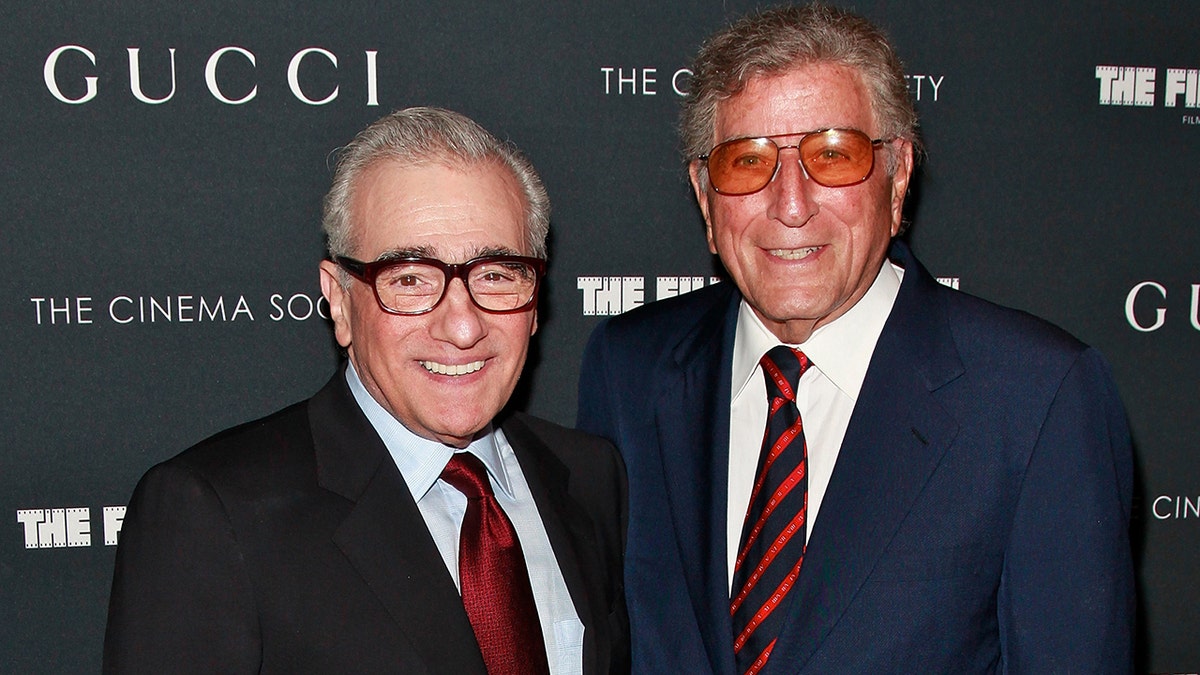 Martin Scorsese and Tony Bennett wearing matching navy suits with blue and red ties