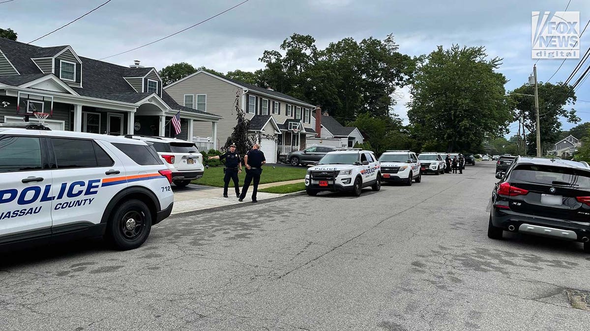 Suffolk County police stationed outside of a home