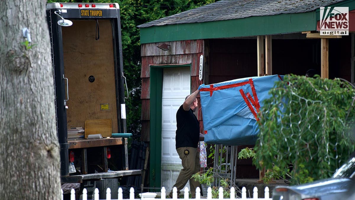 New York State Police remove evidence from the home of Rex Heuermann in Massapequa Park, New York, Saturday, July 15, 2023. Heuermann is charged with six counts of murder related to the bodies found on Gilgo Beach in 2010-2011.