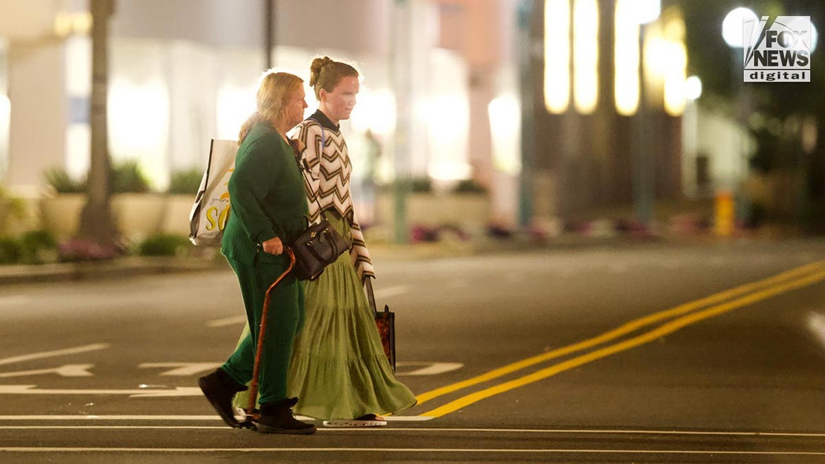 Rex Heuermann's wife, Asa Ellerup and daughter, Victoria Heuermann walk on the street