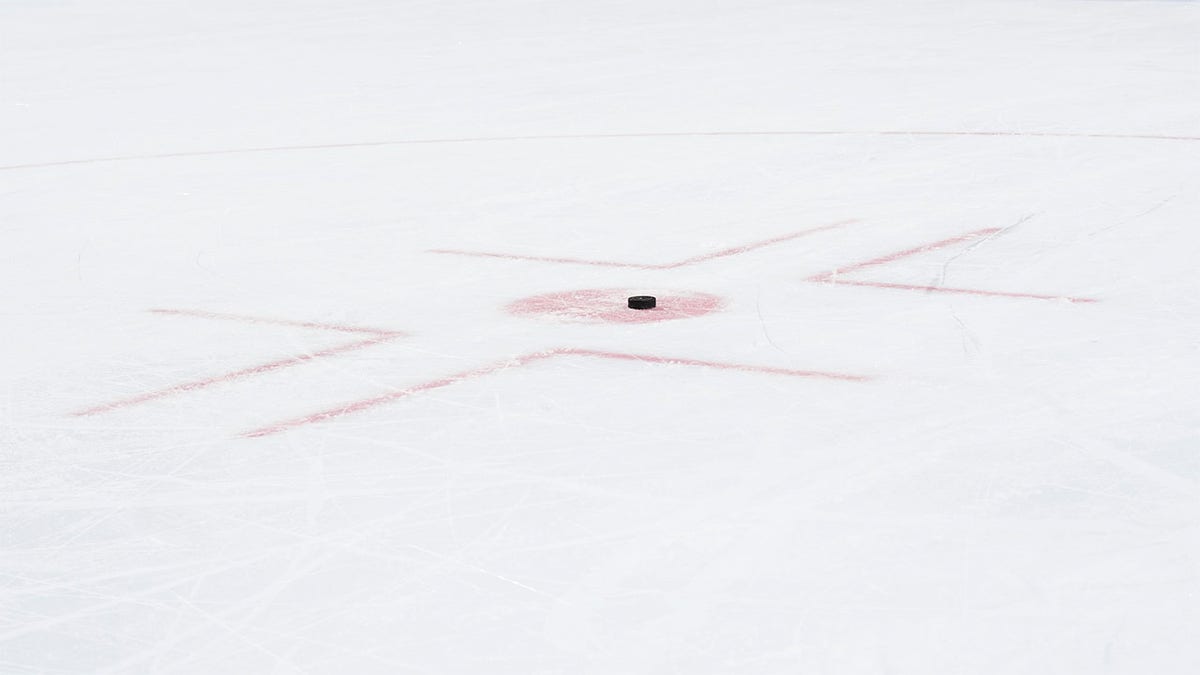 A hockey puck in the faceoff circle