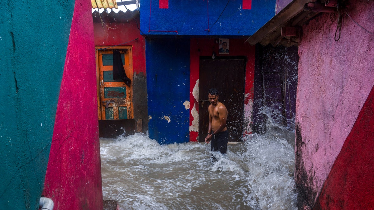 A man watches waves caused by high tide