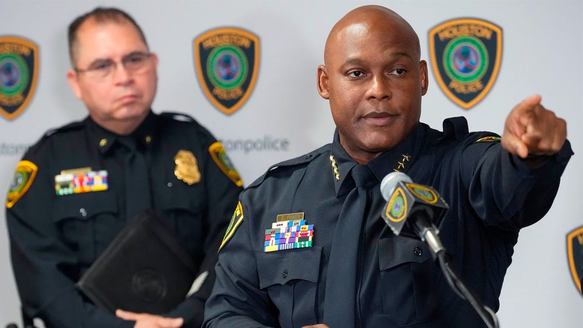 A police chief points at a reporter to take questions at a Houston press conference.