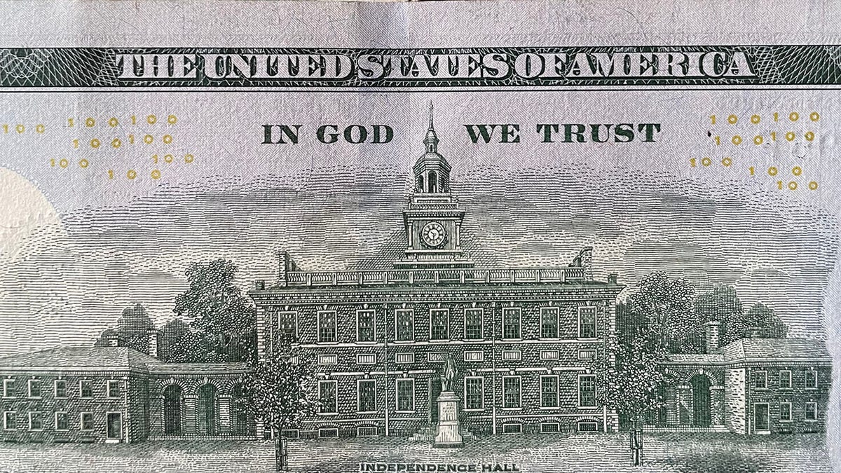 A picture of a piece of currency with "In God We Trust" on the back