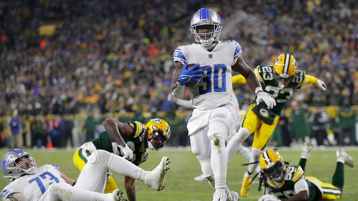 Jamaal Williams rushes during a game