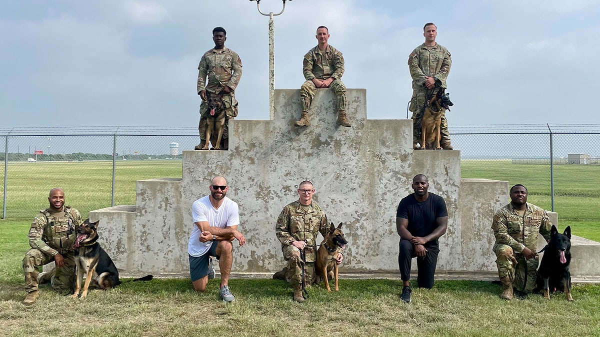 Joe Thomas and Whitney Mercilus with dog trainers