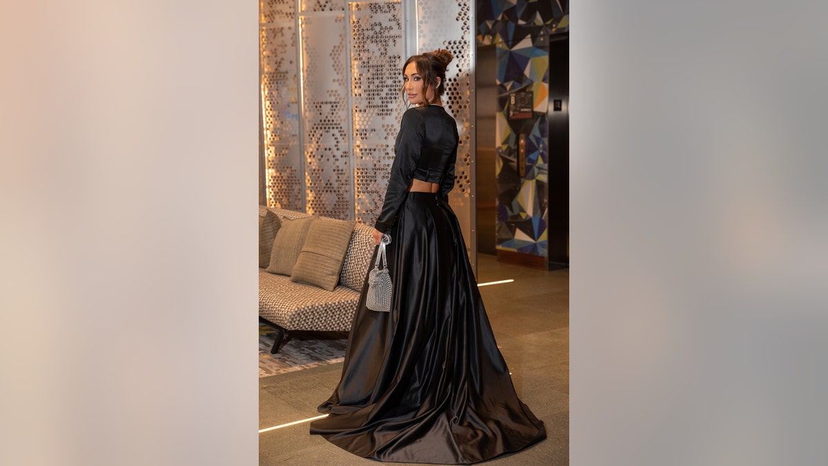 Leah Van Dale wearing a long black skirt and a long sleeved black top