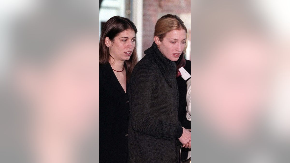 Carolyn and Lauren Bessette in dark coats walking
