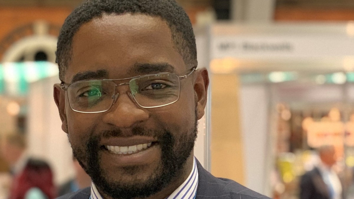 King Lawal in glasses, smiling