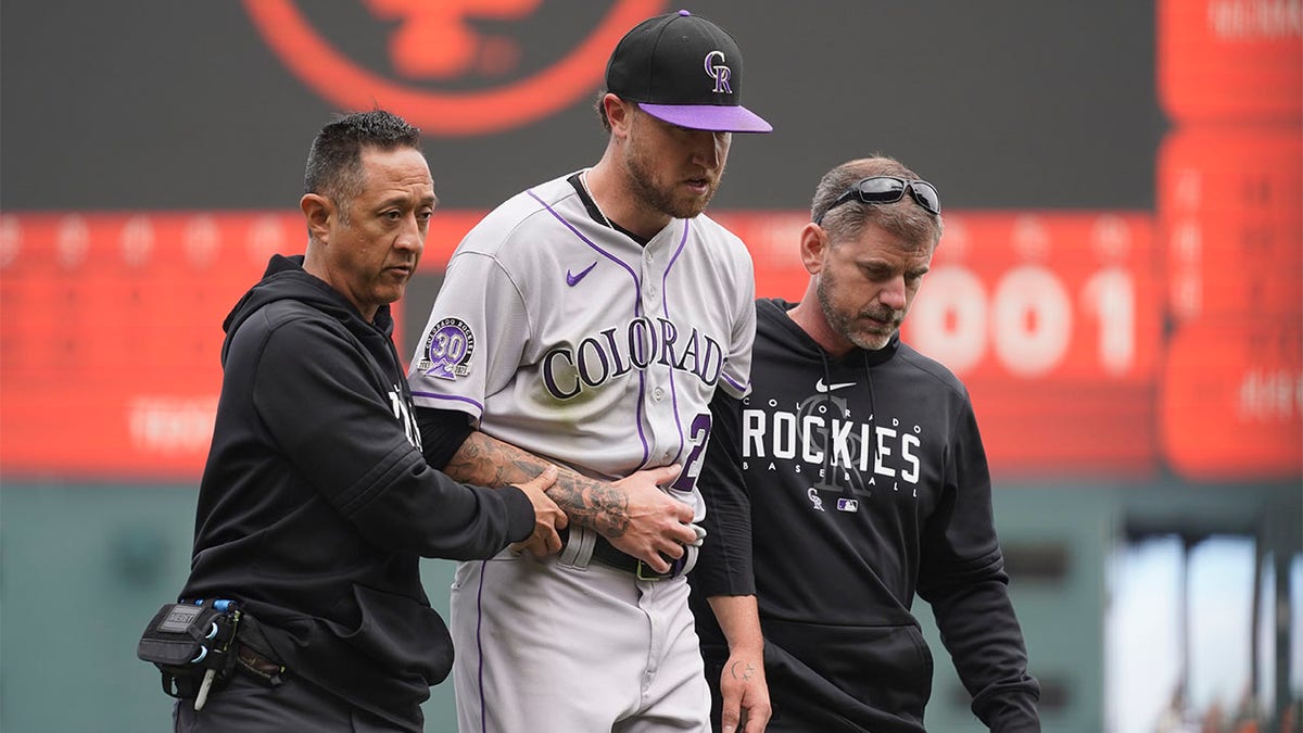 Kyle Freeland helped off mound