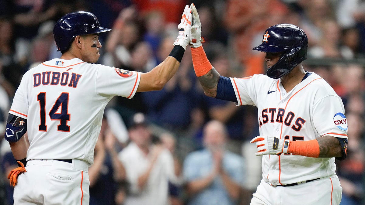 Martin Maldonado celebrates with Mauricio Dubon