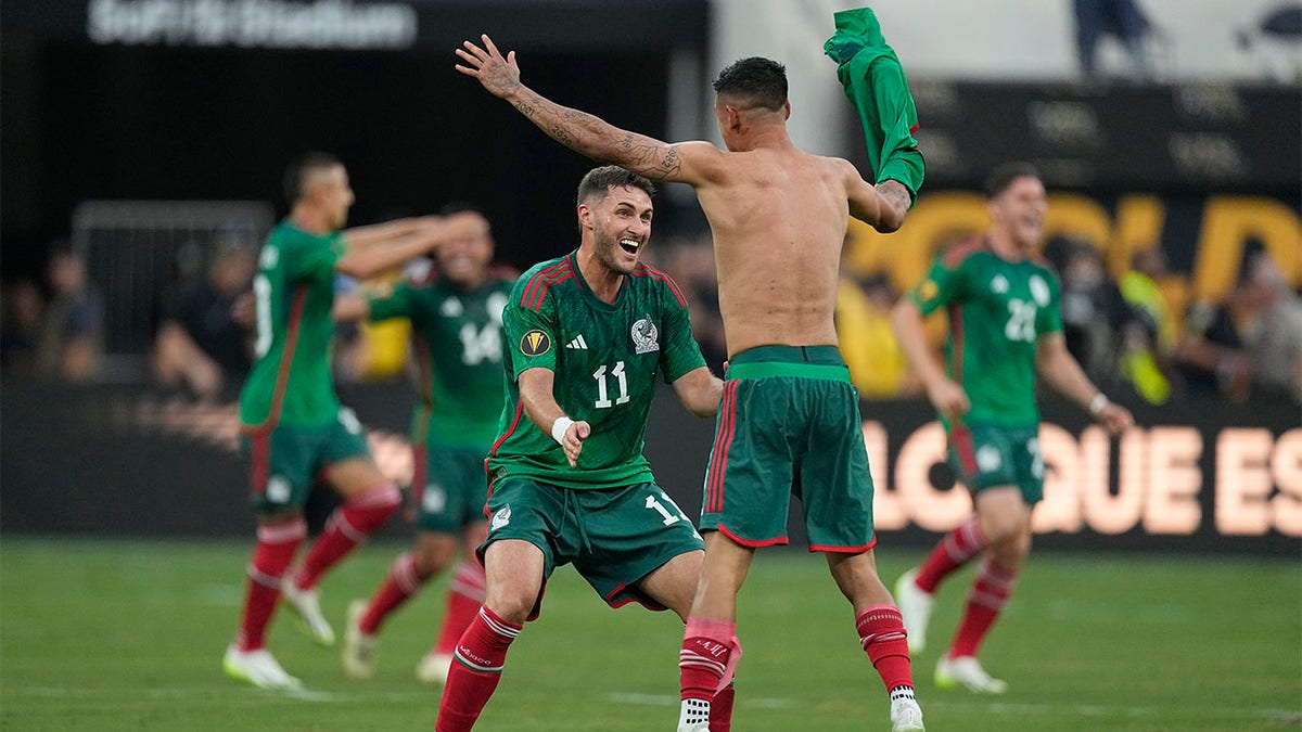 Santiago Giménez celebrates with teammate