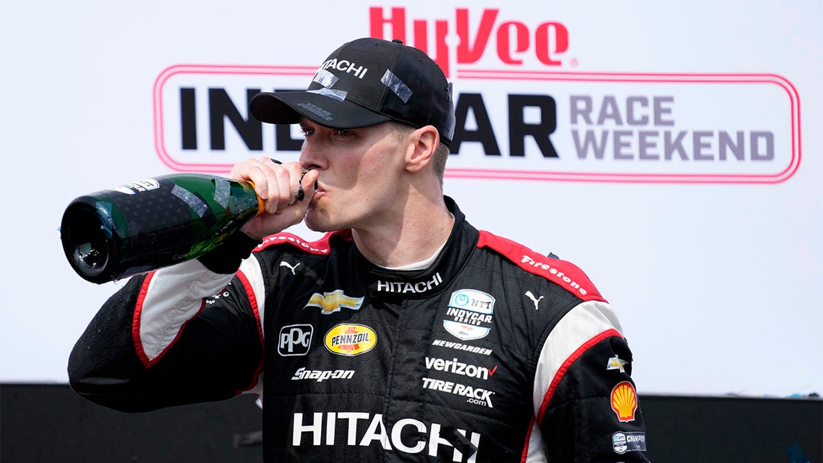 Josef Newgarden drinks champagne