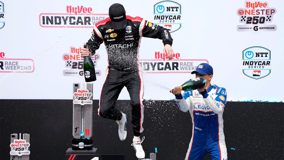 Alex Palou sprays Josef Newgarden with champagne