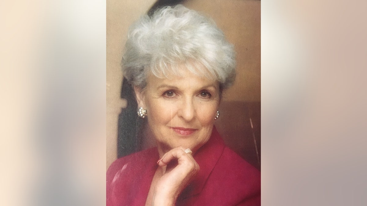 A portrait of Loretta Bowersock wearing a burgundy dress