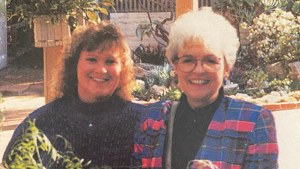 Terri Bowersock and her mother Loretta Bowersock smiling and posing in colorful sweaters