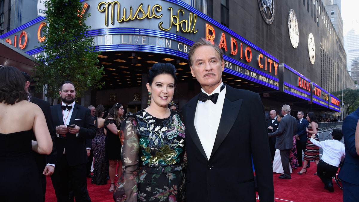 Phoebe Cates and Kevin Kline pose in front of Radio City Music Hall