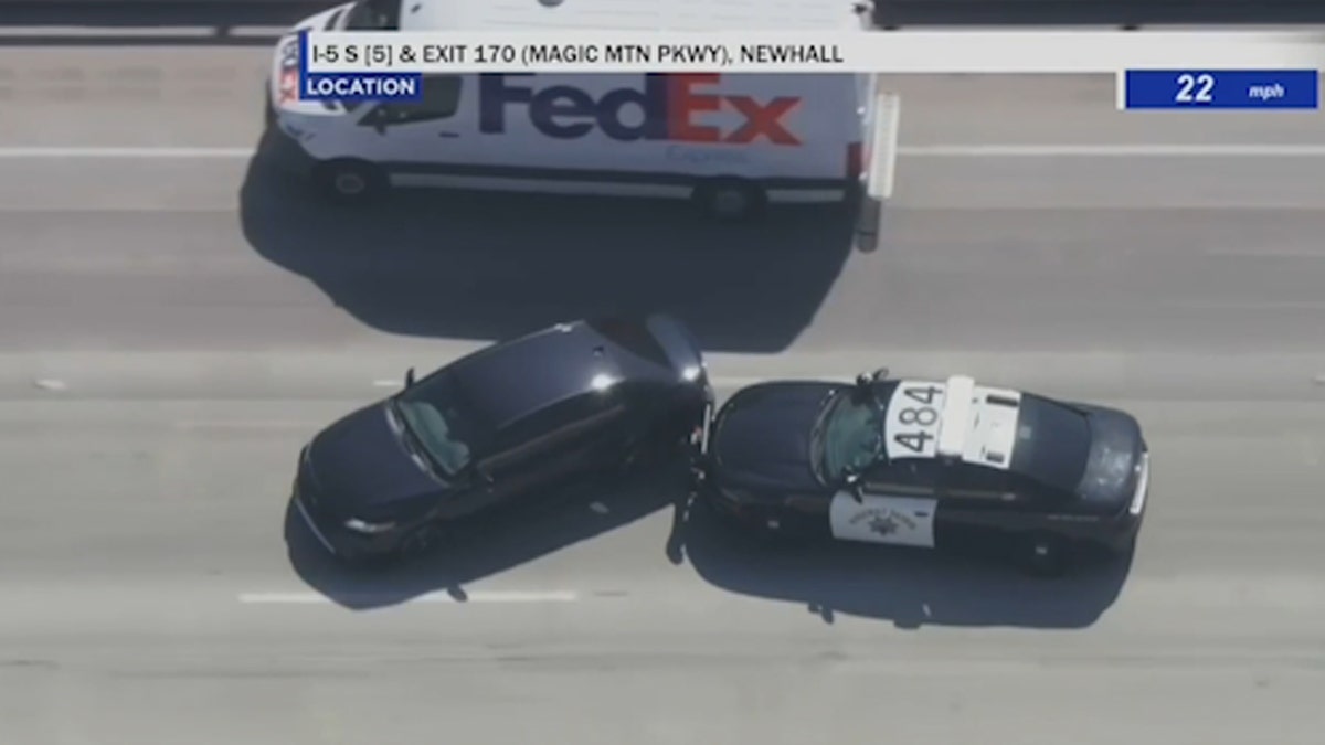 Police stop homeless man driving stolen black Toyota camry on highway next to a FedEx truck
