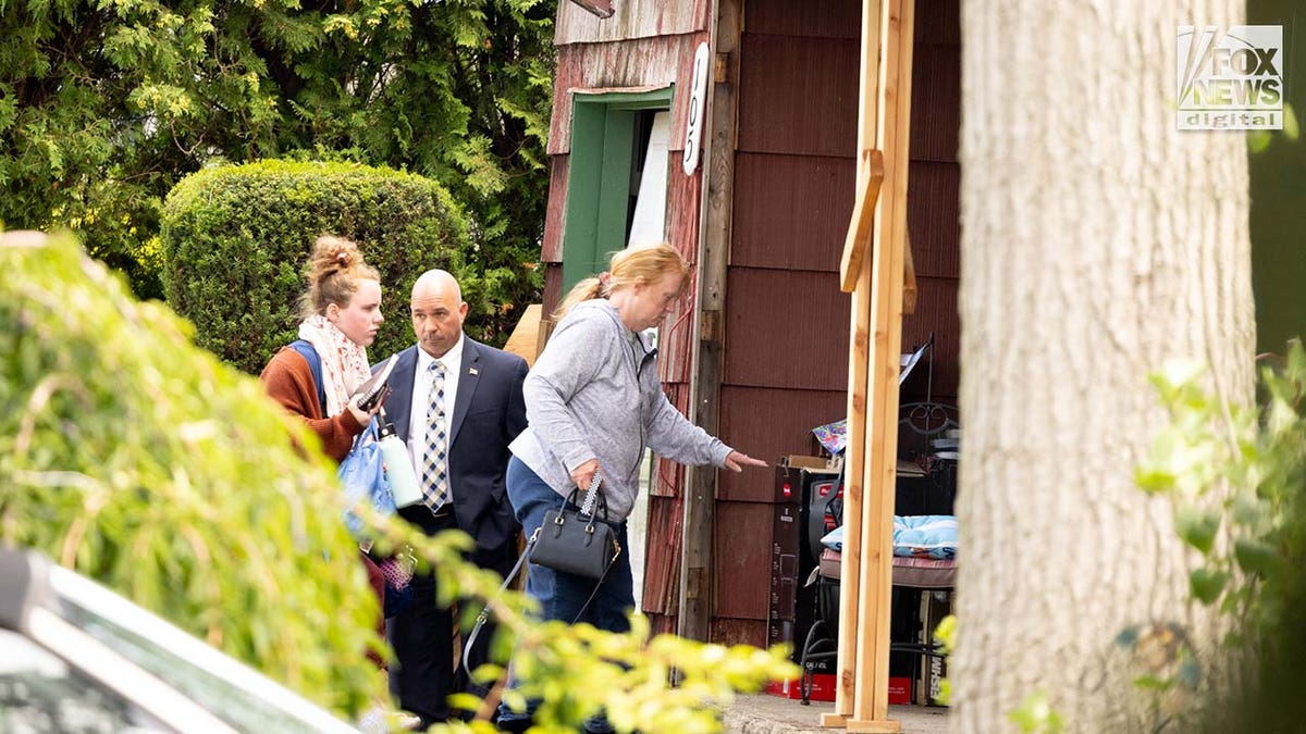 Asa Ellerup and Victoria Heuermann enter their home in Long Island