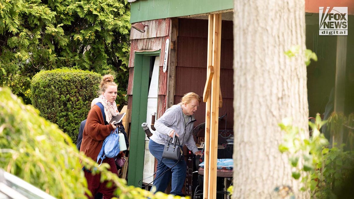 Asa Ellerup and Victoria Heuermann enter their home in Long Island