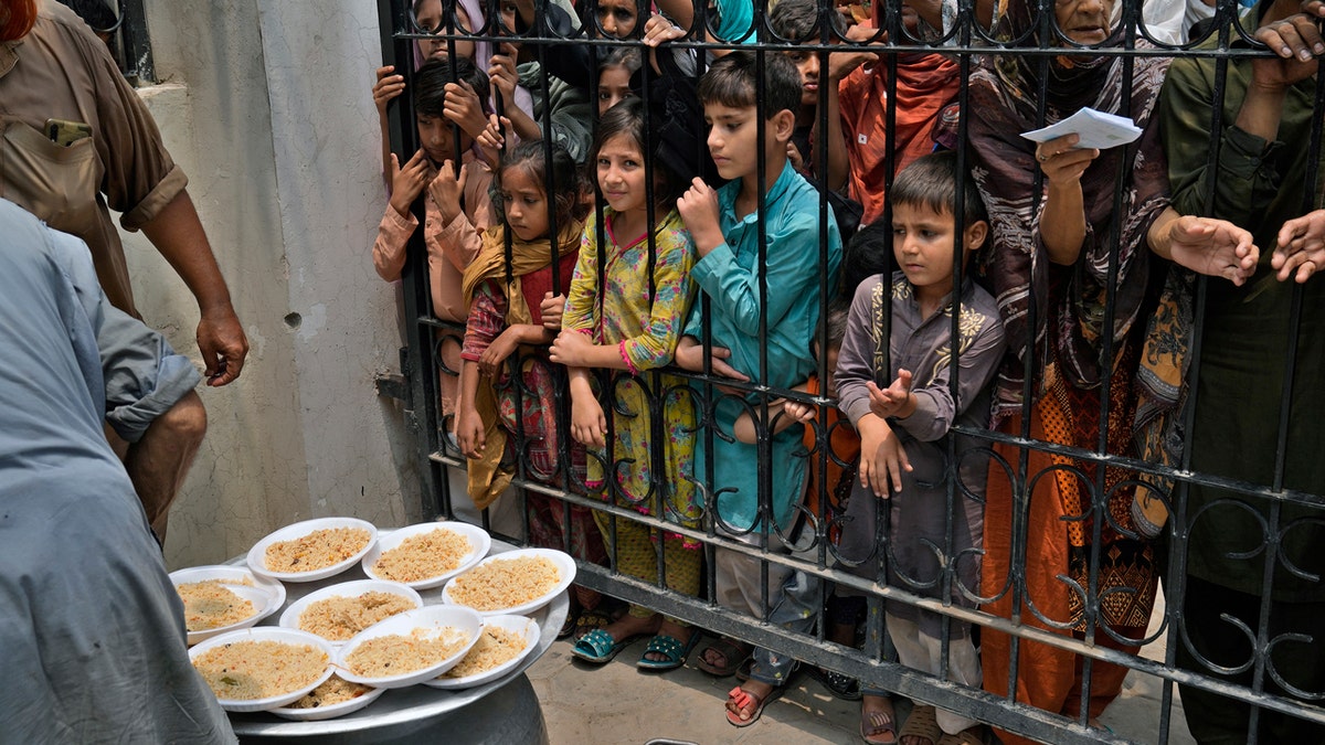 Women and children wait for food