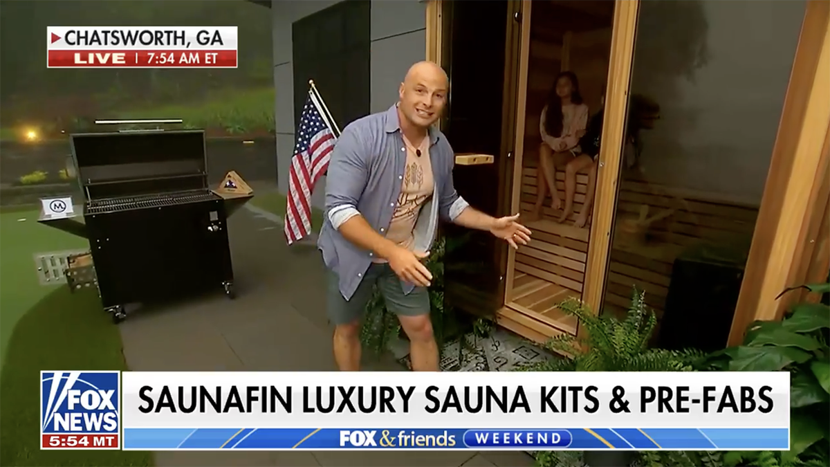 Chip wade standing by a sauna