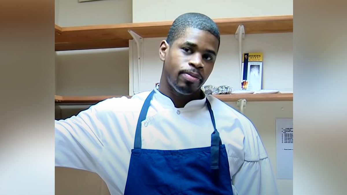 Tafari Campbell waring white shirt and blue apron