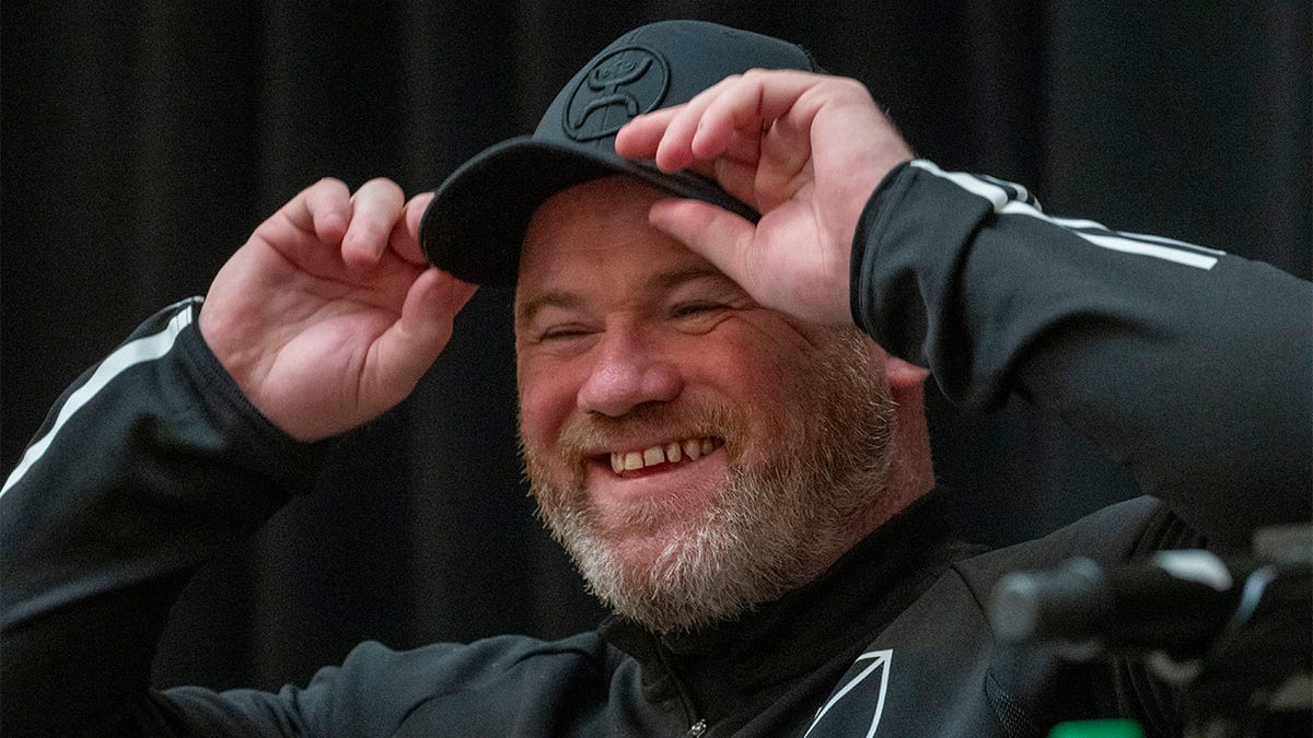 Wayne Rooney smiles at press conference