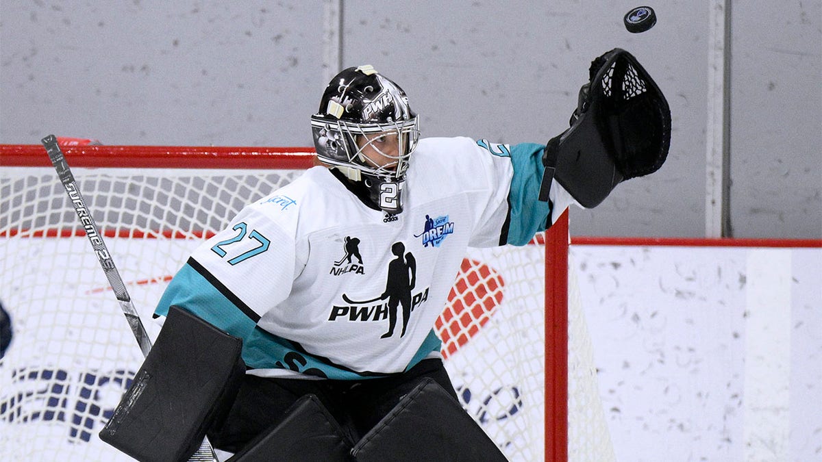 Erica Howe reaches for puck