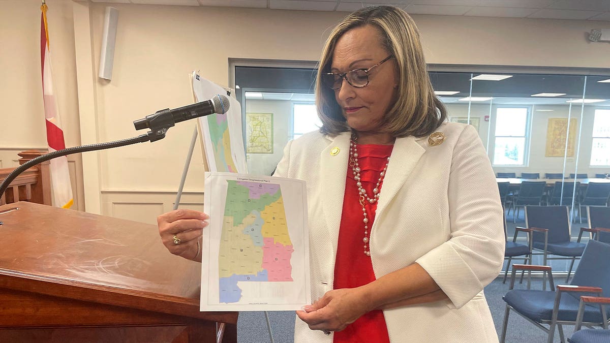 senator holds a copy of a GOP congressional map proposal 
