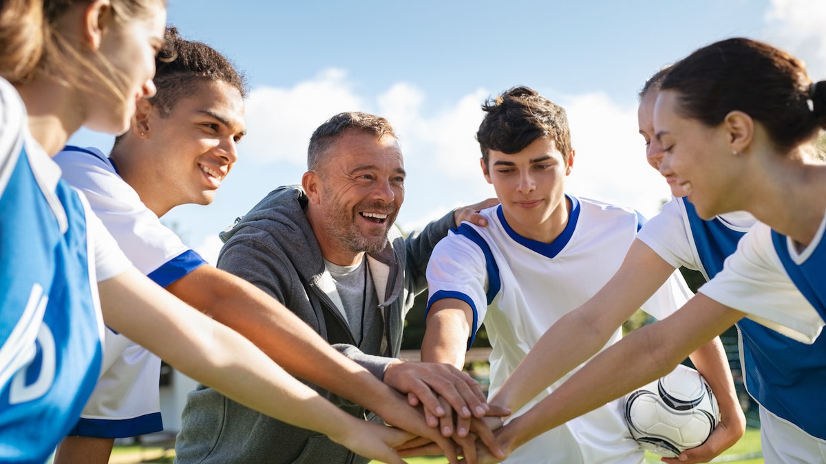 Coach with teen players