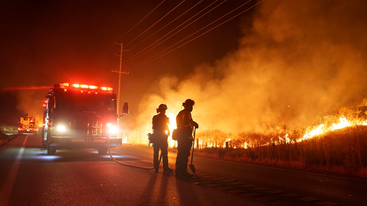 firefighters near flames