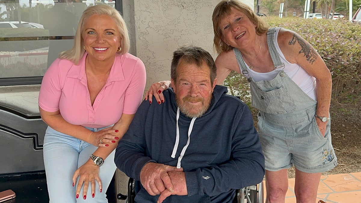 Three people pose for a photo together