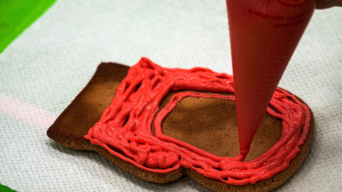 A Christmas cookie being decorated