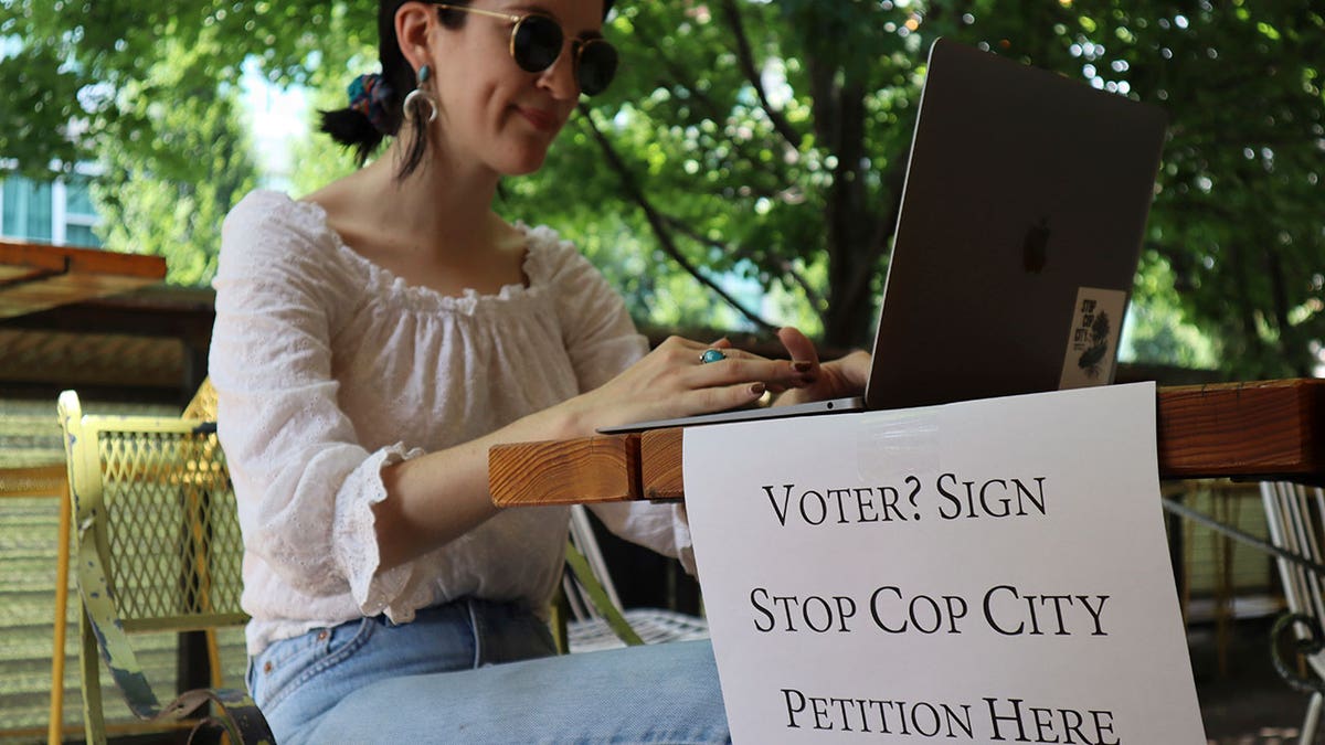woman working while collecting signatures for petition