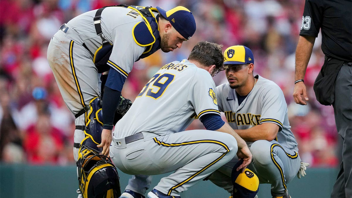 Members of the Brewers check on Corbin Burnes