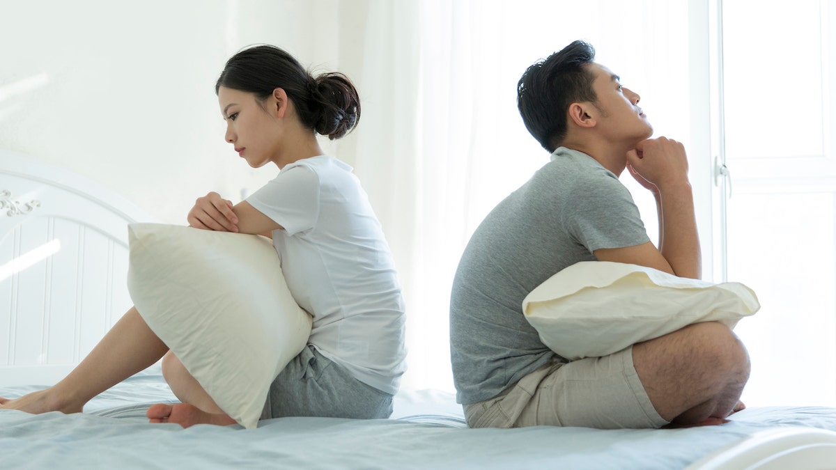 Couple sitting on bed