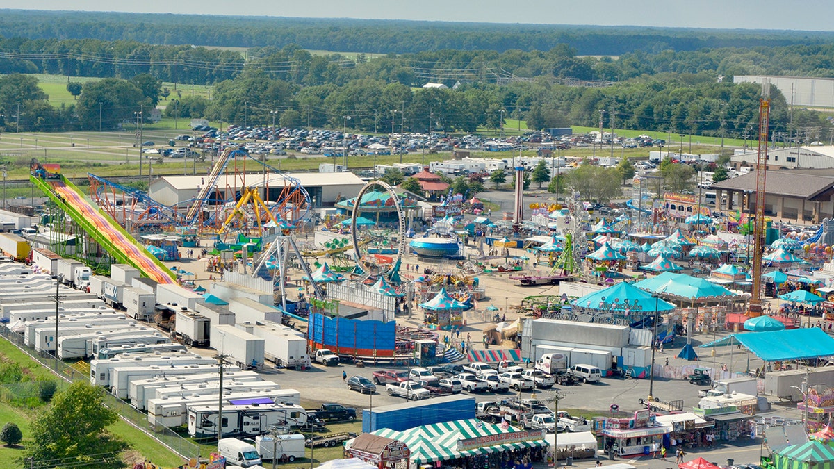 A view of the Delaware State Fair from the air, showing amusement park rides, food stands, and dozens of tents