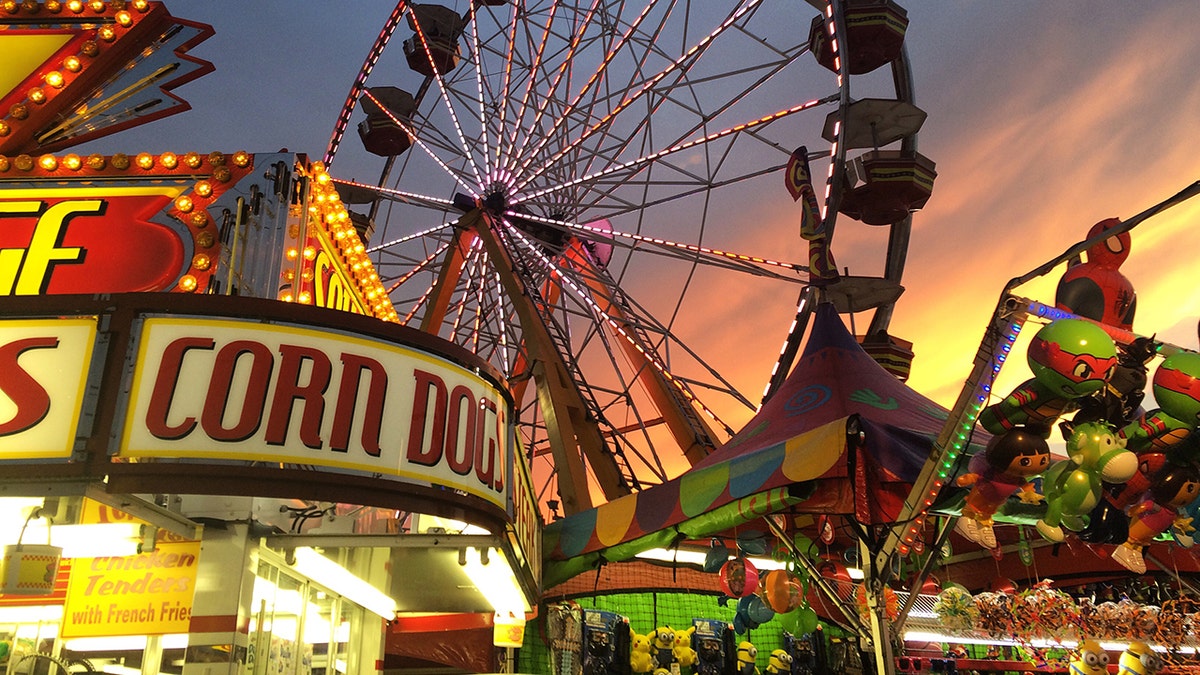 A food stand, fair games with prizes, and Ferris wheel at the Delaware State Fair