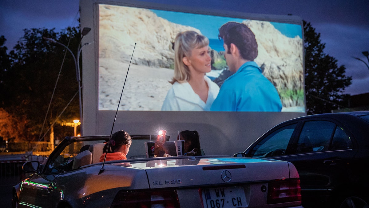 Cars watching a movie in a drive-in theater