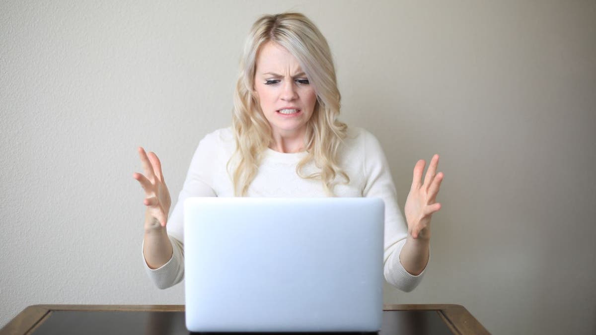 frustrated woman in front of laptop computer