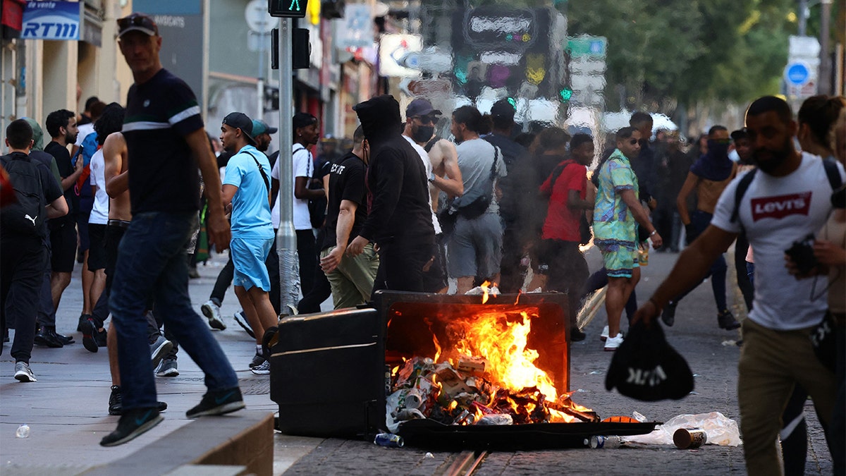 French protestors burning a trash can on the street.