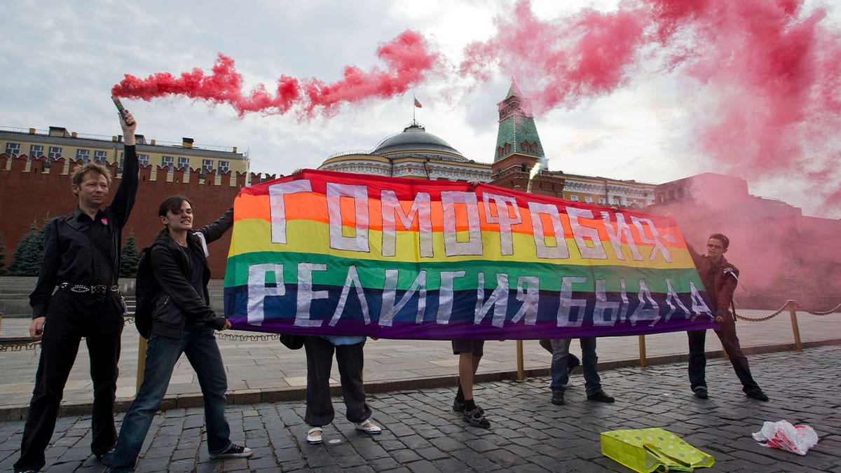 Gay rights activists hold banner